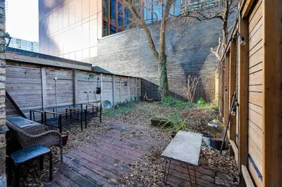 a patio with chairs and a table and a building at Spacious 3 Bedroom Toronto Home with Piano in Toronto