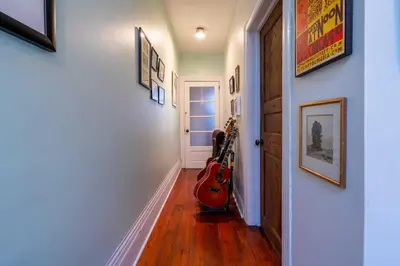 a hallway with a guitar sitting next to a door at Spacious 3 Bedroom Toronto Home with Piano in Toronto