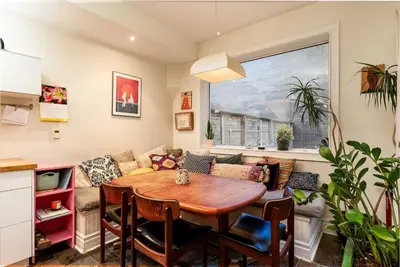 a living room with a table and a couch at Spacious 3 Bedroom Toronto Home with Piano in Toronto