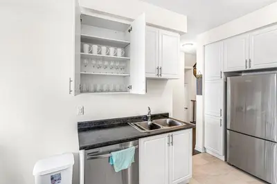 a kitchen with white cabinets and a sink at Spacious 3BR House with Modern Comforts in Thorold