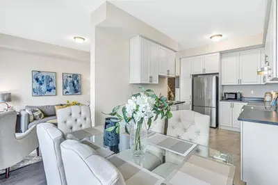 a kitchen and living room with a table and chairs at Spacious 3BR House with Modern Comforts in Thorold