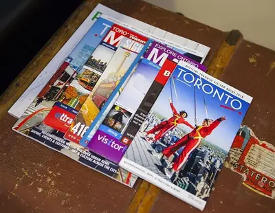 two magazines sitting on top of a table at Private Suite With Private Entrance - Entire Place in Toronto