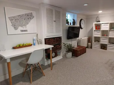 a living room with a white desk and a television at Private Suite With Private Entrance - Entire Place in Toronto