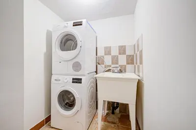 a washing machine and a sink in a bathroom at Lower-Level Classic House in Richmond Hill in Richmond Hill
