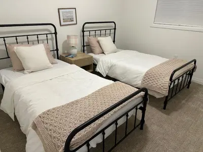 two twin beds in a room with at Serene Escape Near Niagara Falls - Premium in Thorold