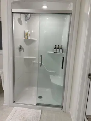 a shower with a glass door in a bathroom at Serene Escape Near Niagara Falls - Premium in Thorold