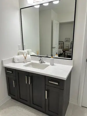 a bathroom with a sink and a large mirror at Serene Escape Near Niagara Falls - Premium in Thorold