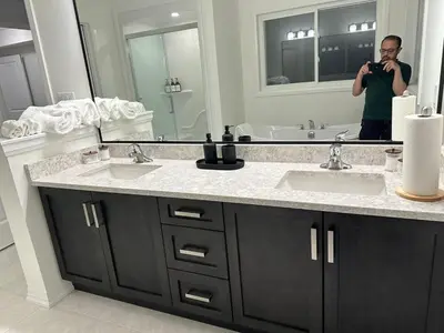 a man taking a picture of a bathroom mirror at Serene Escape Near Niagara Falls - Premium in Thorold