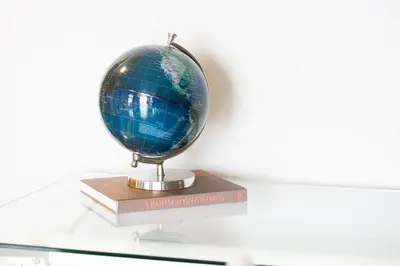 a globe sitting on top of a stack of books at Lux Penthouse Retreat Near Yorkville with Parking in Toronto