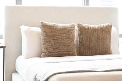 a group of pillows sitting on top of a bed at Lux Penthouse Retreat Near Yorkville with Parking in Toronto
