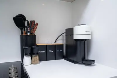 a kitchen counter with a coffee maker and utensils at Stylish Yorkville Condo Sleeps 3 Prime Location in Toronto