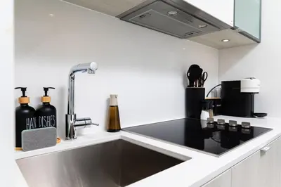 a kitchen with a sink and a counter top at Stylish Yorkville Condo Sleeps 3 Prime Location in Toronto