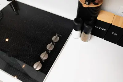 a black stove top with two knobs on a counter at Stylish Yorkville Condo Sleeps 3 Prime Location in Toronto