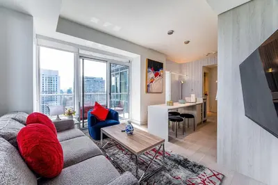 a living room with a couch and a table at Luxury Yorkville Two Bedroom Condo With Views and Parking in Toronto