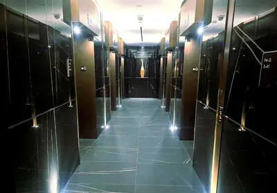 a hallway in a building with a tile floor at Luxury Yorkville Two Bedroom Condo With Views and Parking in Toronto