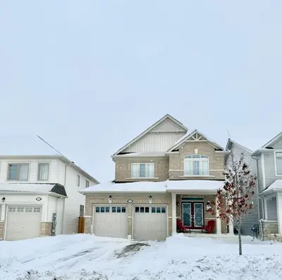 a large house with snow on the driveway at Charming Short-Term Stay Near Downtown Fergus & Elora Mill in Fergus