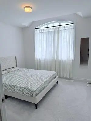 a white bedroom with a bed and a window at Charming Short-Term Stay Near Downtown Fergus & Elora Mill in Fergus