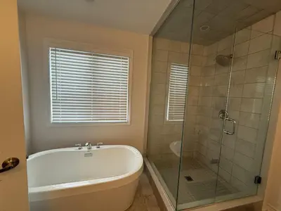 a bathroom with a tub and a glass shower at Charming Short-Term Stay Near Downtown Fergus & Elora Mill in Fergus