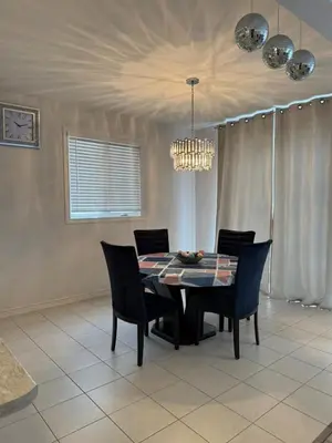 a dining room table with chairs and a chandelier at Charming Short-Term Stay Near Downtown Fergus & Elora Mill in Fergus