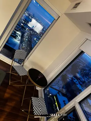 a room with two large windows with a view of a city at Modern 1 bedroom with private bathroom near Toronto airport in Toronto
