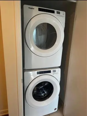 a washing machine and a dryer in a room at Modern 1 bedroom with private bathroom near Toronto airport in Toronto