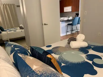 a bedroom with a bed with a blue and white pattern at Bloor Yonge Cozy 1BR And Den Free Parking in Toronto