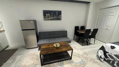 a living room with a couch and a table at Cozy Studio Retreat in Scenic Georgina, Canada in Georgina