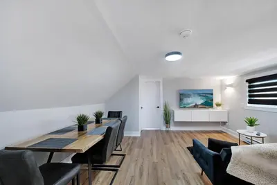 a dining room with a table and chairs at Modern 1 Bdrm with Laundry, BBQ, Deck in Welland