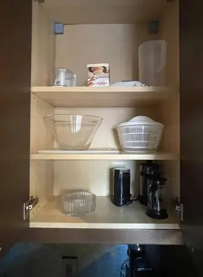 a shelf with bowls and other items on it at 2 Bed Apartment in DT Toronto with Free Parking in Toronto