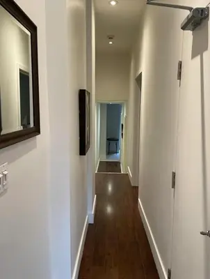 a hallway with white walls and a ceiling fan at 2 Bed Apartment in DT Toronto with Free Parking in Toronto