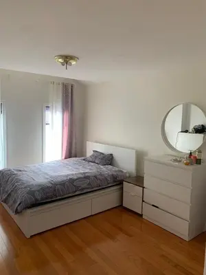 a bedroom with a bed and a mirror and a dresser at Cozy House in Richmond Hill