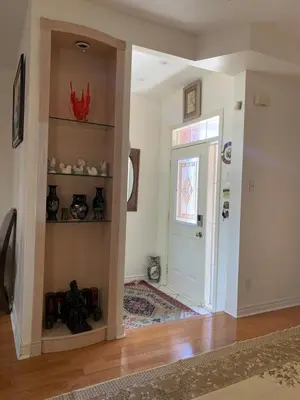 a room with a hallway with a door and shelves at Cozy House in Richmond Hill