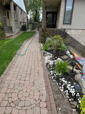 a brick path in front of a house with a hose at The Pantry Suite - Cozy Basement Stay in Mississauga
