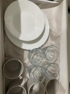 a group of wine glasses and plates in a refrigerator at The Pantry Suite - Cozy Basement Stay in Mississauga