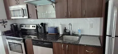 a kitchen with a sink and a counter top at Liberty Village Condo Lake and BMO Field View in Toronto