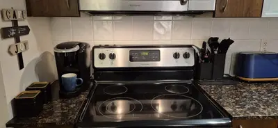 a stove top oven sitting in a kitchen at Liberty Village Condo Lake and BMO Field View in Toronto