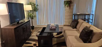 a living room with a couch and a flat screen tv at Liberty Village Condo Lake and BMO Field View in Toronto
