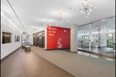 a lobby with a sign in the middle of a building at Liberty Village Condo Lake and BMO Field View in Toronto
