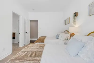 two beds in a room with white walls at Modern 3BR Home in Stouffville | Quiet & Spacious in Aurora