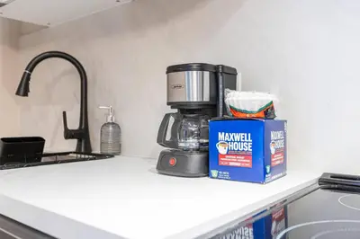 a kitchen counter with a coffee maker and a box of milk at Modern 3BR Home in Stouffville | Quiet & Spacious in Aurora