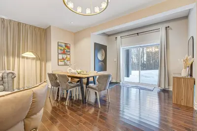 a dining room and living room with a table and chairs at Modern 3BR Home in Stouffville | Quiet & Spacious in Aurora