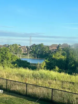 a view of a body of water behind a fence at Designer Escape by the Pond in Kitchener