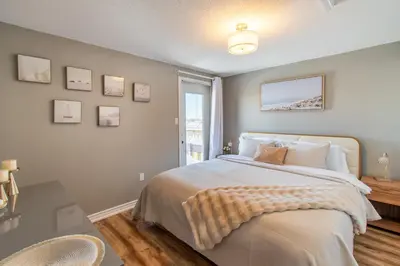 a bedroom with a large bed and a window at Cozy Barrie retreat near lake Simcoe and parks in Barrie