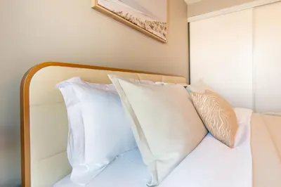 a bedroom with a bed with white pillows at Cozy Barrie retreat near lake Simcoe and parks in Barrie