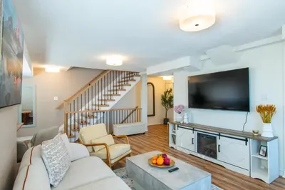 a living room with a couch and a tv at Cozy Barrie retreat near lake Simcoe and parks in Barrie