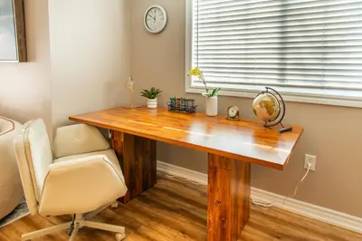 a desk in a room with a chair and a clock at Cozy Barrie retreat near lake Simcoe and parks in Barrie
