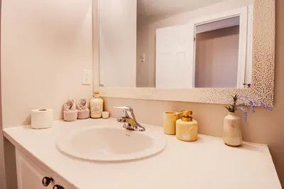 a bathroom counter with a sink and a mirror at Cozy Barrie retreat near lake Simcoe and parks in Barrie