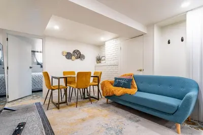 a living room with a blue couch and a table at Multi-level home near Squareone, Airport, 3Parking in Mississauga
