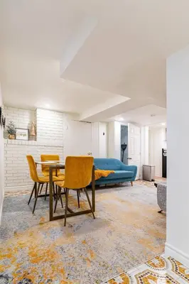a living room with a table and chairs and a couch at Multi-level home near Squareone, Airport, 3Parking in Mississauga