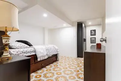 a bedroom with a bed and a table with a lamp at Multi-level home near Squareone, Airport, 3Parking in Mississauga